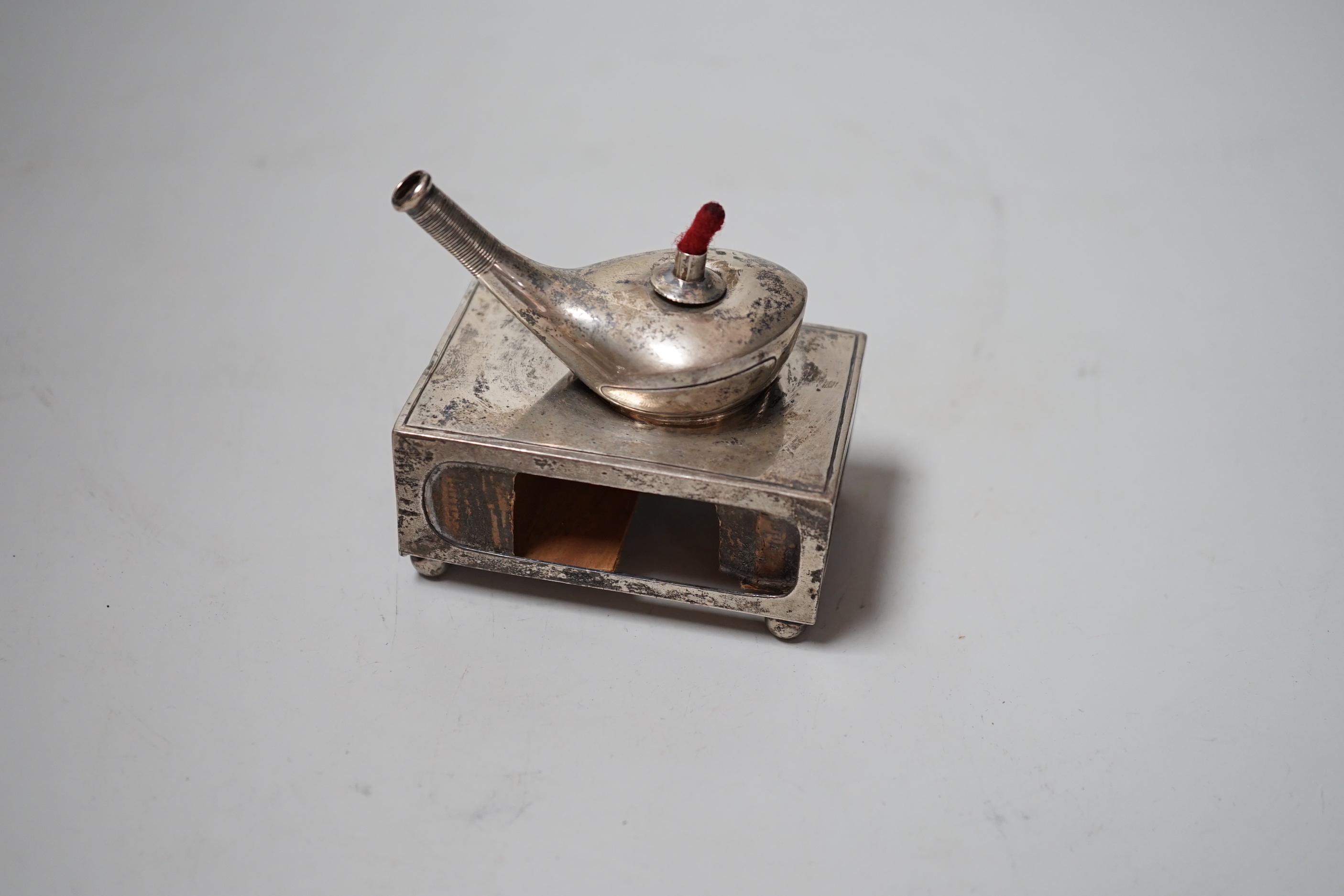 An unusual Edwardian silver matchbox sleeve, surmounted with a lamp shaped perpetual lighter, Crisford & Norris, Birmingham, 1908, 74mm.